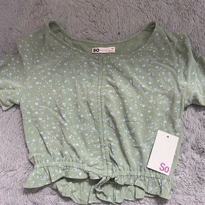 This is a green cropped top, it has a rousing string to adjust the crop